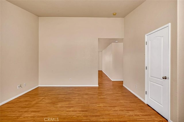 unfurnished room with wood finished floors and baseboards