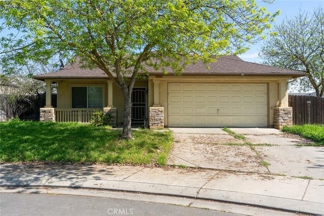 view of front of house with stucco siding, stone siding, a garage, and driveway