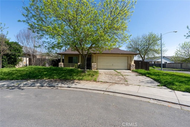 ranch-style house with stucco siding, driveway, a garage, and fence