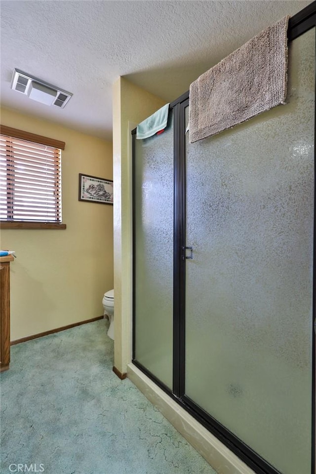 full bathroom with baseboards, visible vents, a stall shower, a textured ceiling, and toilet