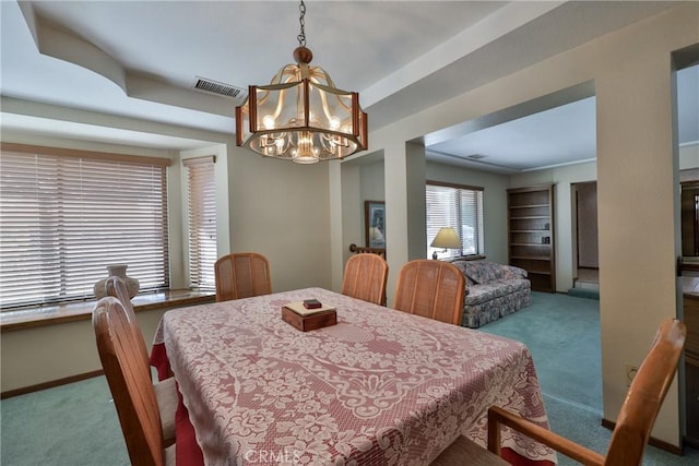 dining area featuring a chandelier, carpet flooring, baseboards, and visible vents