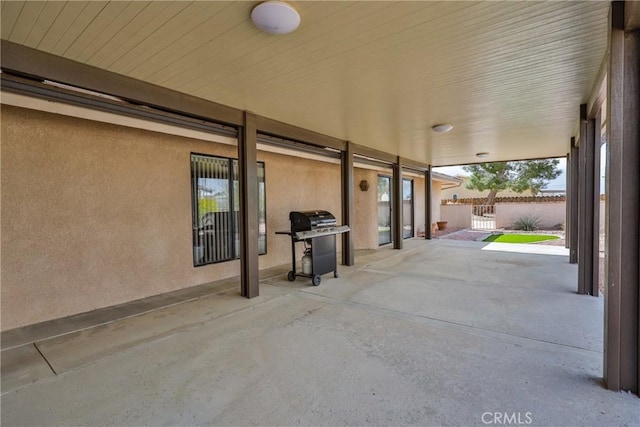 view of patio with grilling area and fence