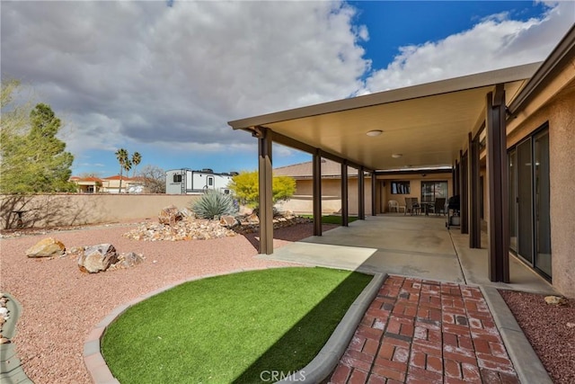 view of yard with a fenced backyard and a patio