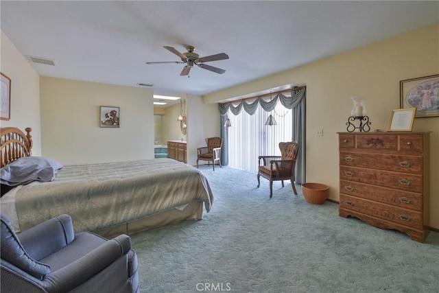 carpeted bedroom with ensuite bath, access to outside, visible vents, and ceiling fan