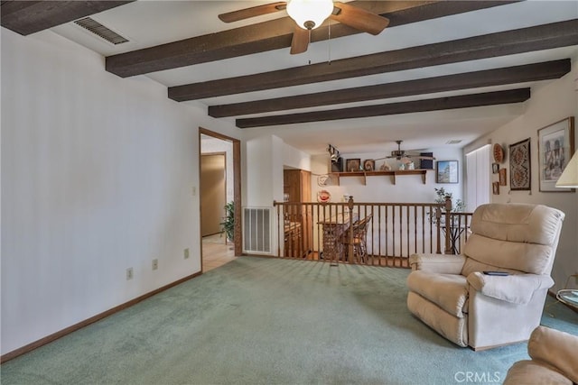 sitting room featuring beamed ceiling, an upstairs landing, visible vents, and carpet floors