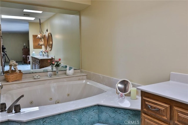 bathroom with visible vents, a skylight, and a whirlpool tub