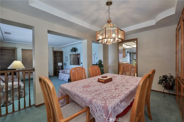 dining space featuring a tray ceiling, visible vents, and carpet