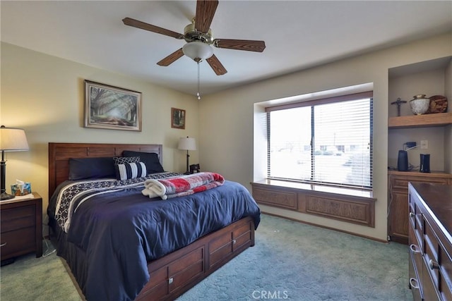 bedroom with light carpet and a ceiling fan