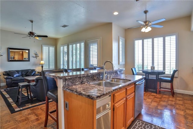 1412 San Clemente Cir, Corona, CA 92882 - kitchen with a ceiling fan, baseboards, visible vents, and a sink