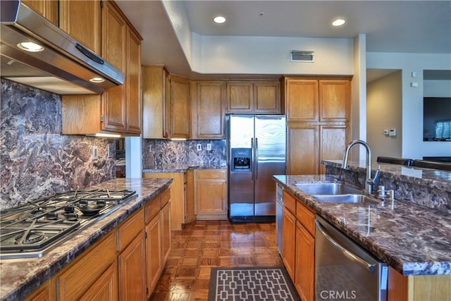 1412 San Clemente Cir, Corona, CA 92882 - kitchen with under cabinet range hood, appliances with stainless steel finishes, brown cabinetry, and a sink