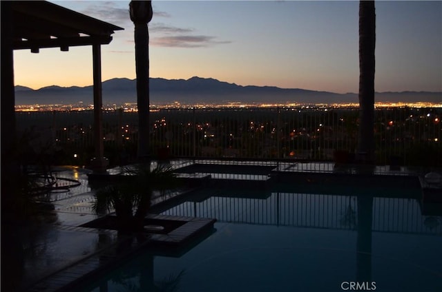 1412 San Clemente Cir, Corona, CA 92882 - pool at dusk with a fenced in pool and a mountain view