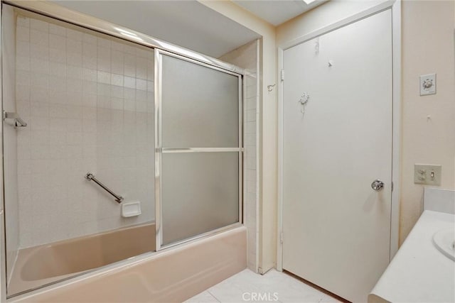 bathroom with tile patterned flooring, vanity, and enclosed tub / shower combo