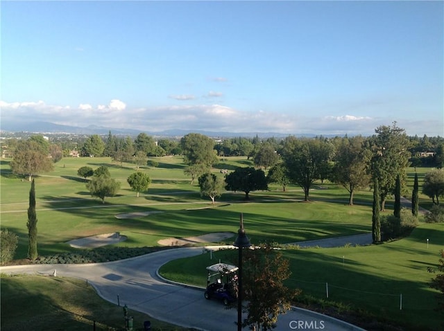 view of property's community with a lawn and golf course view