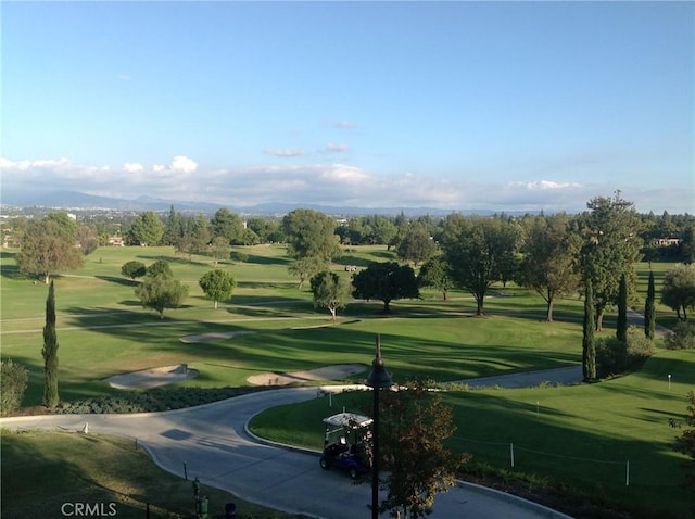 view of home's community featuring a yard and golf course view