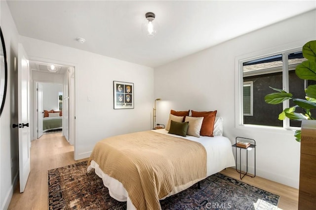 bedroom featuring light wood-type flooring and baseboards