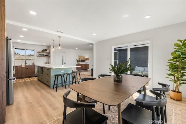 dining room with recessed lighting, visible vents, and light wood finished floors