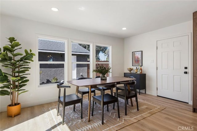 dining area featuring light wood finished floors, recessed lighting, and baseboards