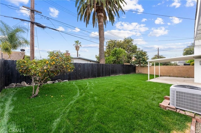 view of yard with central air condition unit, a patio, and a fenced backyard