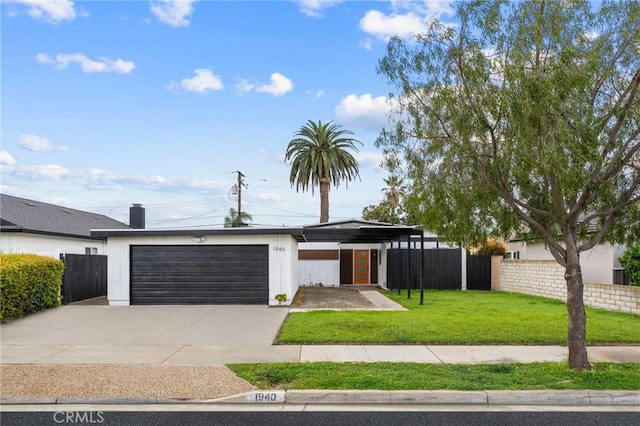 mid-century modern home with driveway, an attached garage, a front lawn, and fence