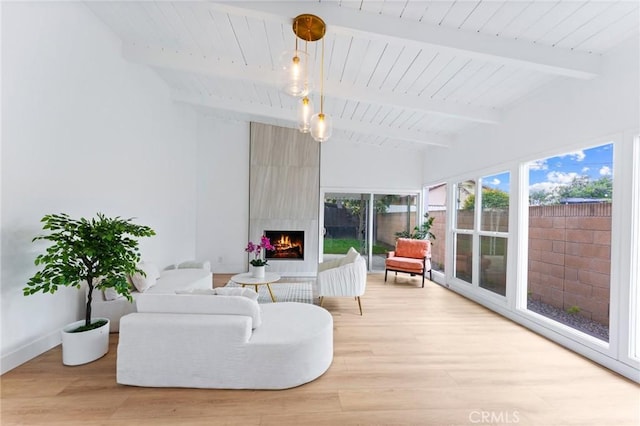 interior space featuring wooden ceiling, vaulted ceiling with beams, and a large fireplace