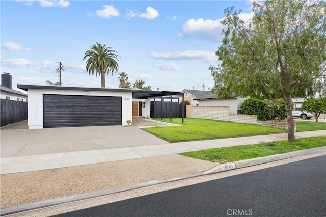 mid-century home with a front yard, an attached garage, fence, and driveway