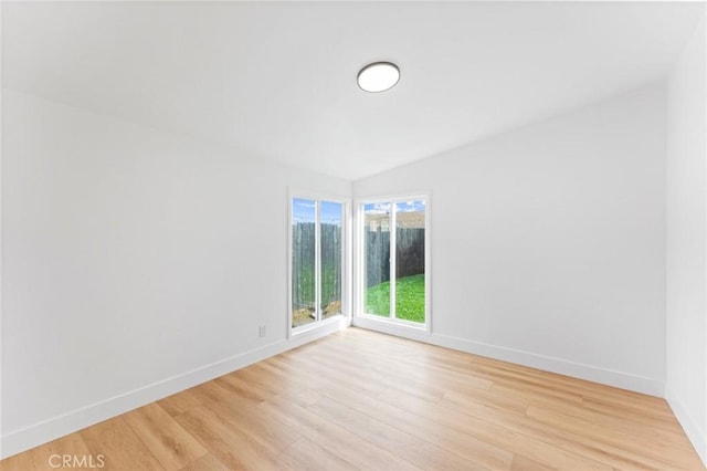 unfurnished room with light wood-style floors and baseboards