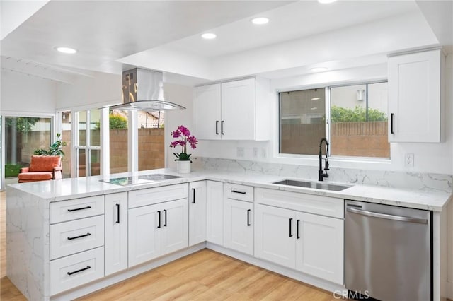 kitchen featuring a peninsula, a sink, stainless steel dishwasher, black electric stovetop, and wall chimney exhaust hood