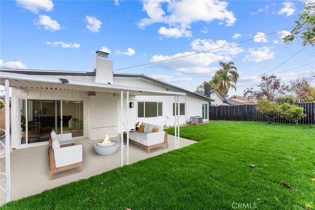 back of property with central air condition unit, a lawn, a patio, a fenced backyard, and brick siding