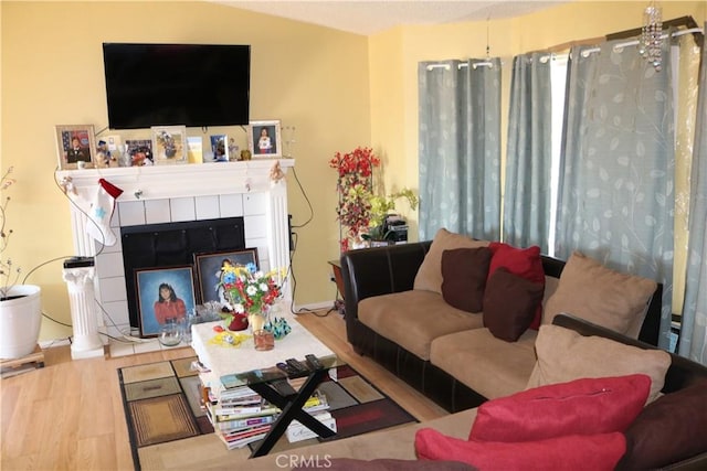 living room featuring wood finished floors and a tile fireplace