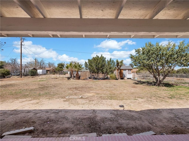 14606 Orange St, Hesperia, CA 92345 - view of yard featuring fence and an outbuilding