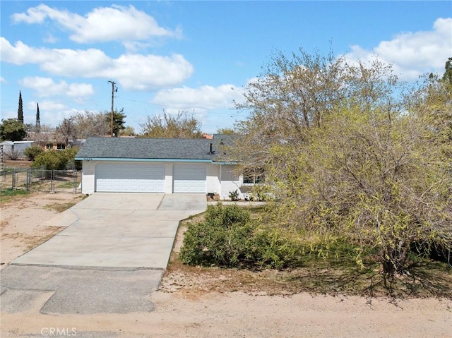 14606 Orange St, Hesperia, CA 92345 - view of front of house featuring an attached garage, fence, driveway, and stucco siding