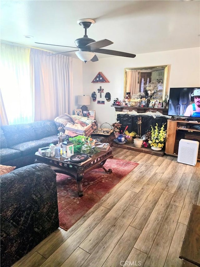 living room featuring wood finished floors and ceiling fan