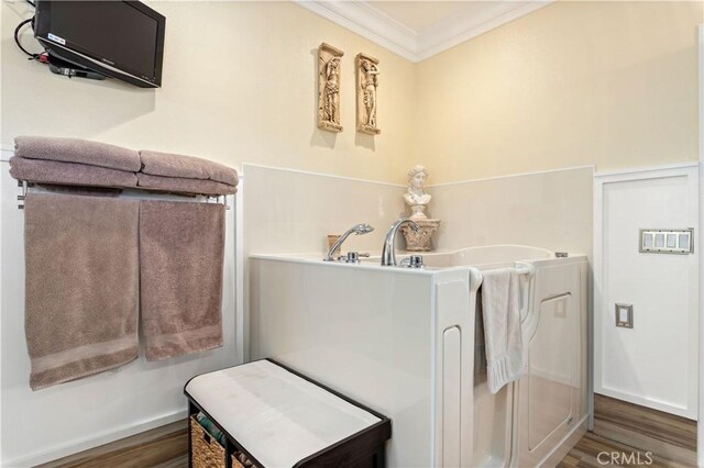 bathroom featuring wood finished floors and ornamental molding