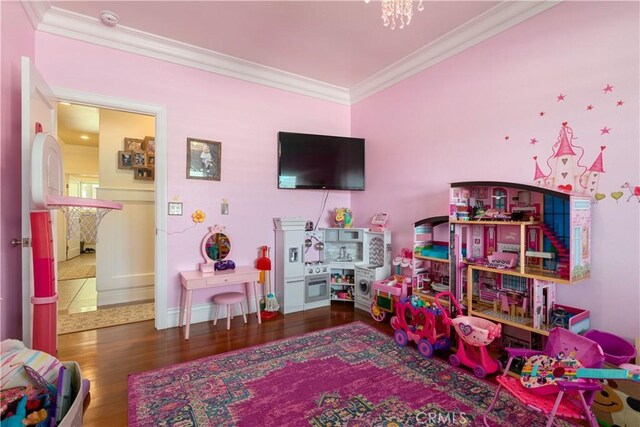 game room featuring wood finished floors, baseboards, and ornamental molding