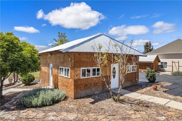 exterior space with a garage and an outdoor structure