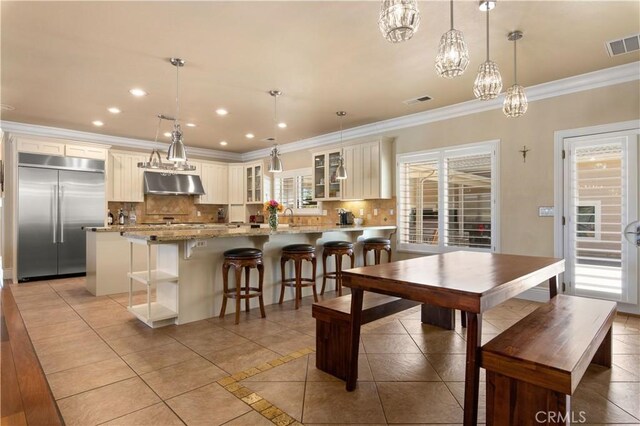 dining room featuring recessed lighting, visible vents, ornamental molding, and light tile patterned floors