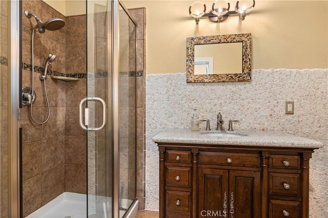 full bathroom featuring a stall shower and vanity