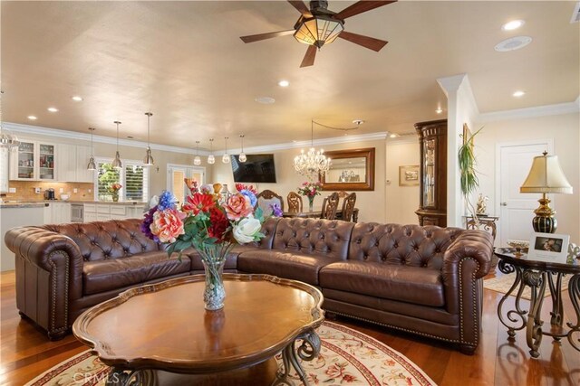 living room featuring recessed lighting, ornamental molding, a ceiling fan, and wood finished floors