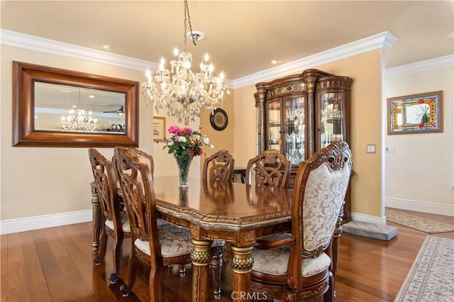 dining area featuring a chandelier, wood finished floors, and crown molding