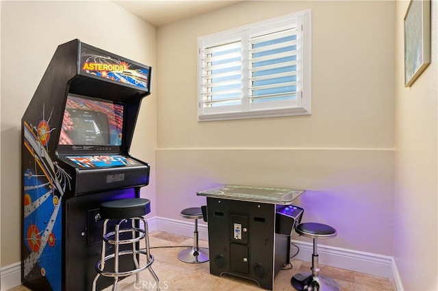 recreation room featuring baseboards