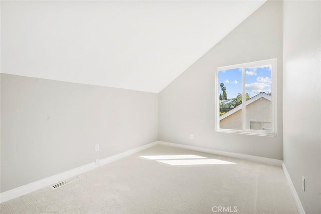 additional living space featuring visible vents, baseboards, carpet, and vaulted ceiling