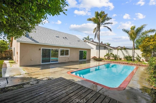 view of swimming pool featuring a deck, a patio area, a fenced backyard, and a fenced in pool