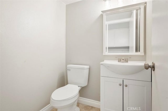 bathroom with tile patterned floors, toilet, vanity, and baseboards