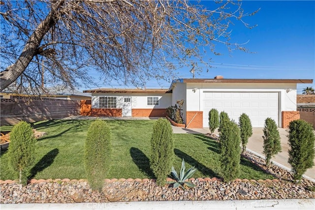 ranch-style house featuring stucco siding, fence, an attached garage, a front yard, and brick siding