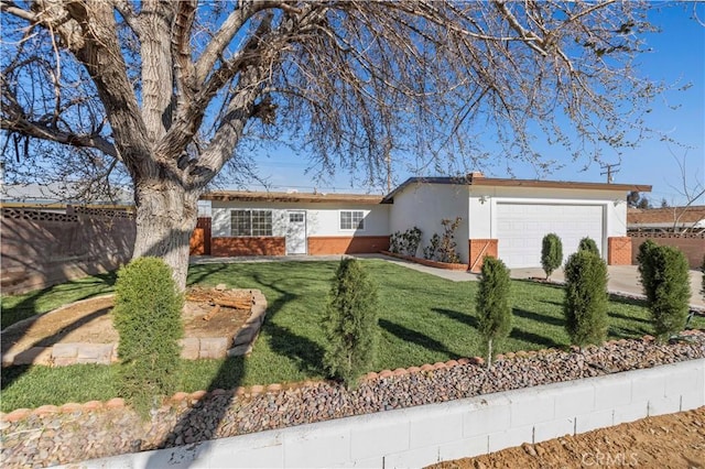 single story home with fence, an attached garage, stucco siding, a front lawn, and brick siding