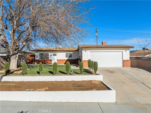 ranch-style house with fence, driveway, an attached garage, a front lawn, and brick siding