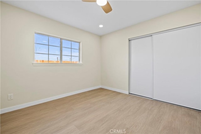 unfurnished bedroom with baseboards, recessed lighting, wood finished floors, a closet, and a ceiling fan