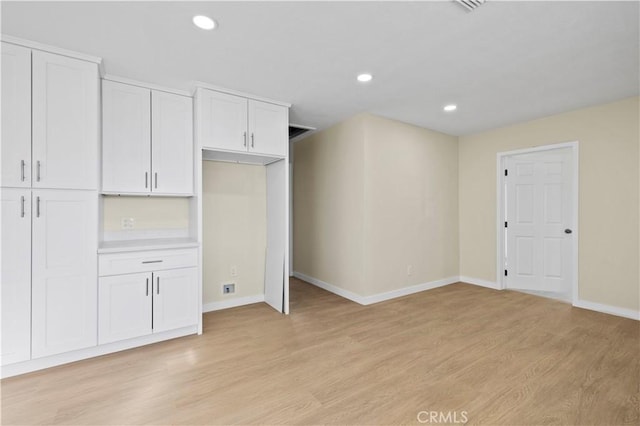 interior space featuring recessed lighting, light wood-type flooring, and baseboards