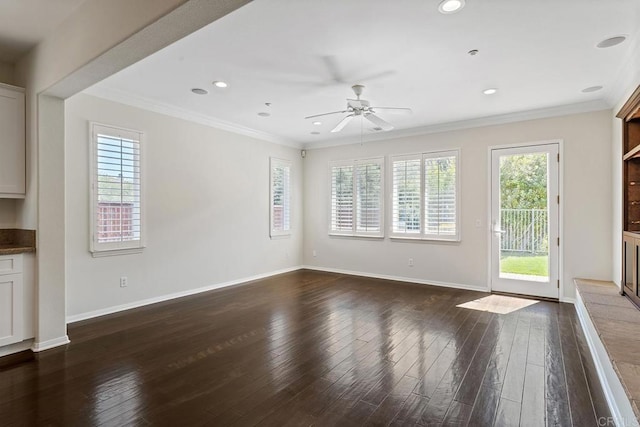 unfurnished living room with baseboards, ornamental molding, and dark wood-style flooring