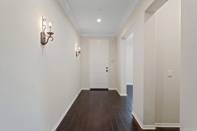 hall featuring recessed lighting, ornamental molding, baseboards, and wood finished floors